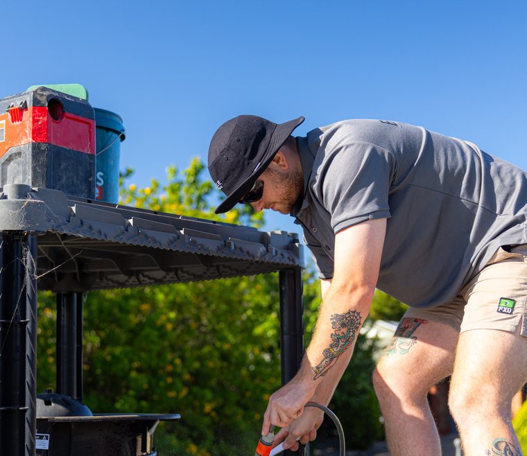 Technician working through evaporative cooling components