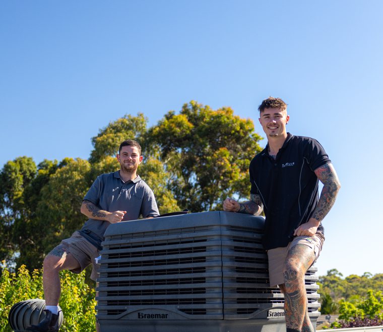 Two technicians fitting a replacement unit