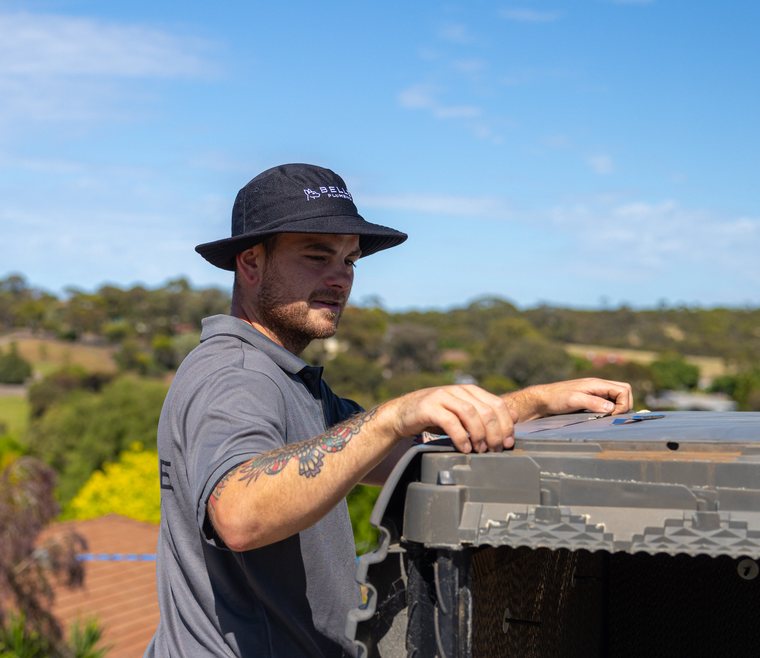 Technician inspecting a rooftop unit